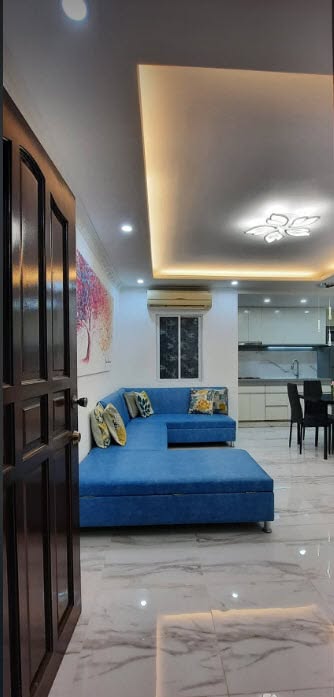 Open-plan living and kitchen with cove lighting